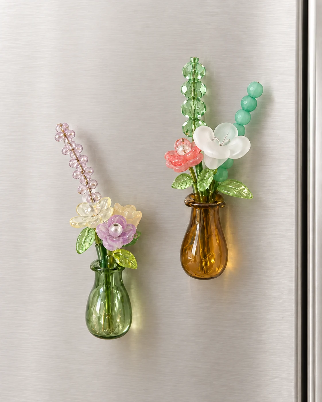 Two miniature beaded flower bouquets in magnet vases attached to a refrigerator