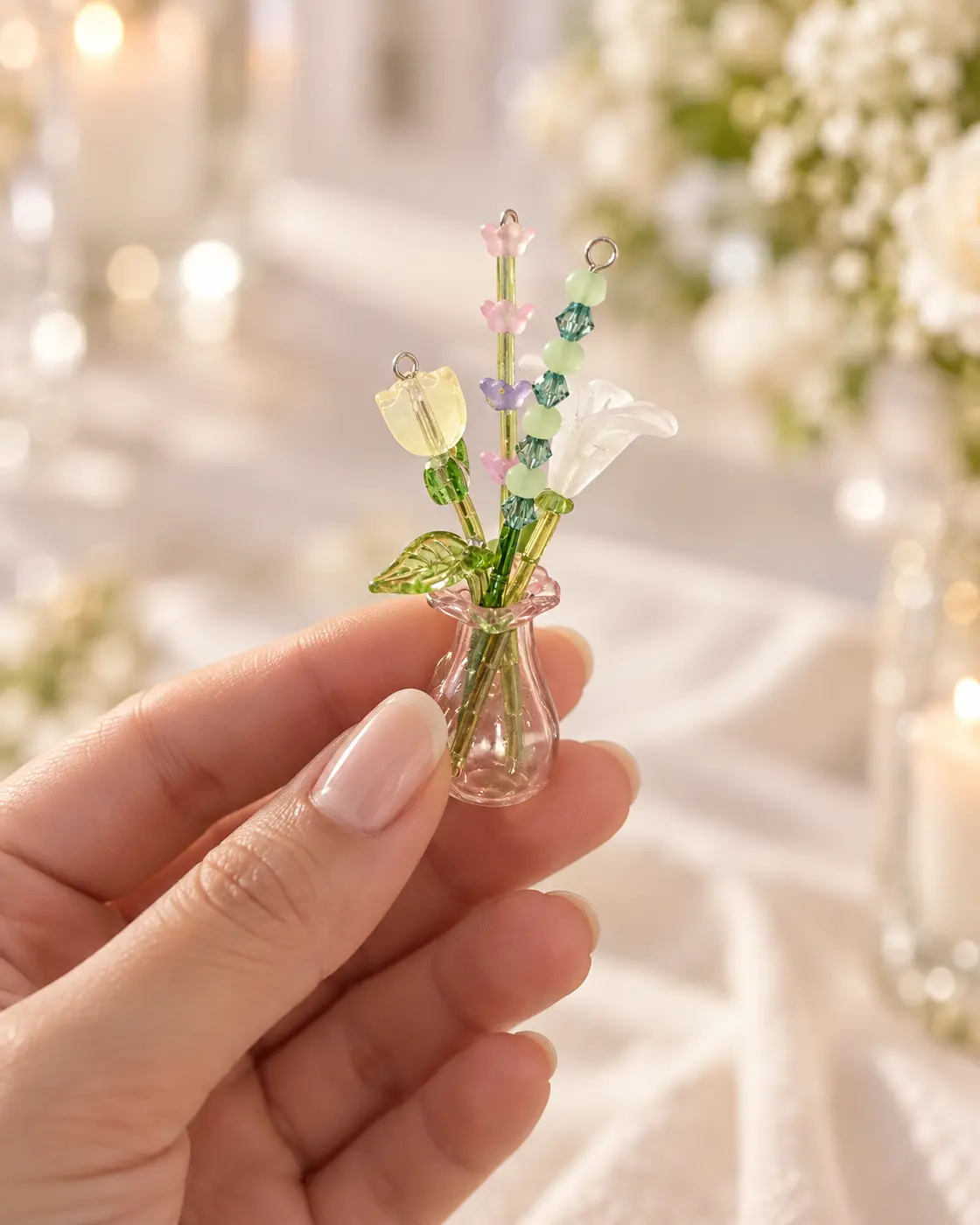 A tiny beaded flower vase held between fingers to show its miniature size