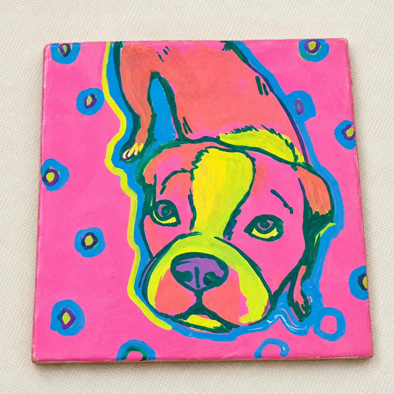 Dog portrait painted on a pink pop art tile